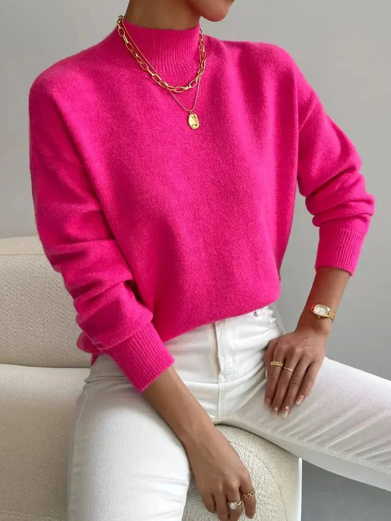 Women's knitted sweater with high neckline, relaxed fit, and ribbed details
