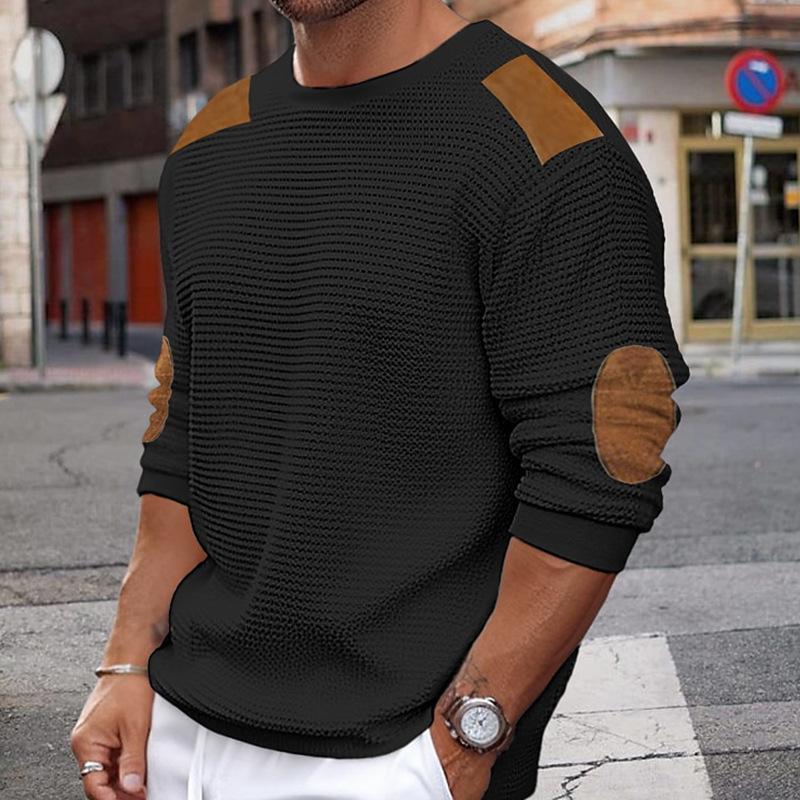 Close-up of men's crew neck knit sweater with structured shoulder and elbow detailing