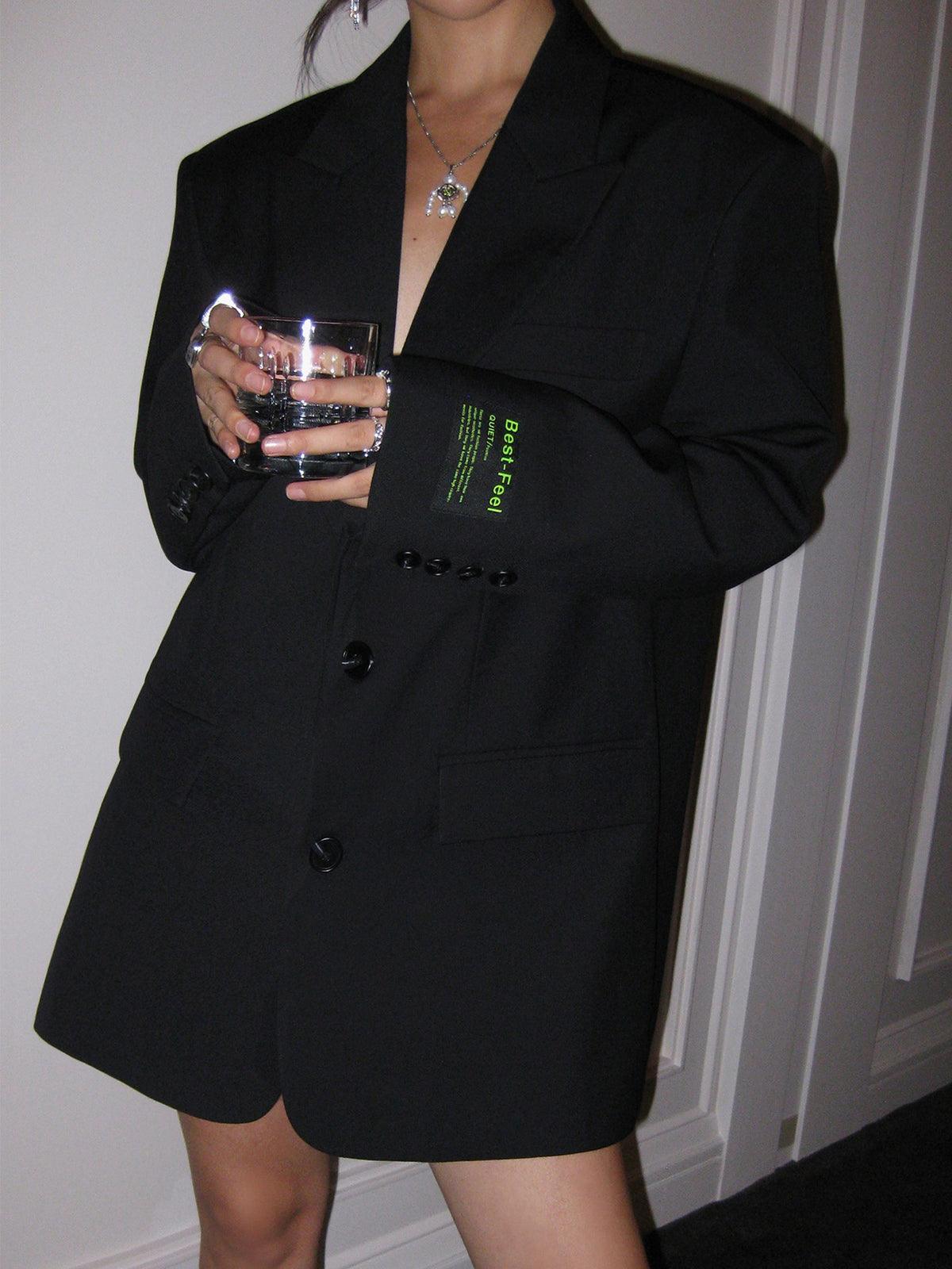 Women's oversized blazer coat flat lay or folded product shot showing overall silhouette