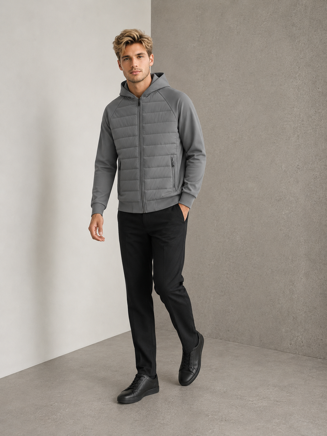 Man wearing a gray hybrid padded hooded jacket