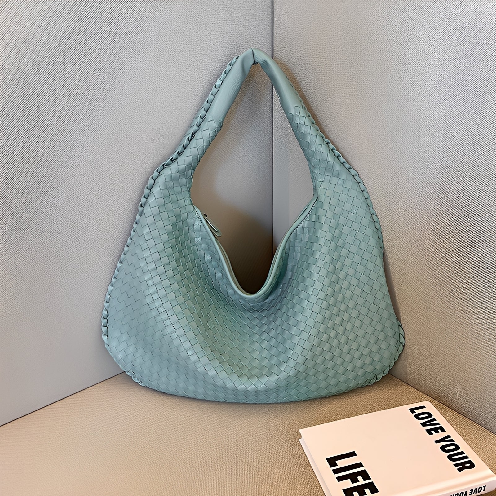 Women's soft faux leather shoulder bag, three-quarter angle view highlighting woven texture