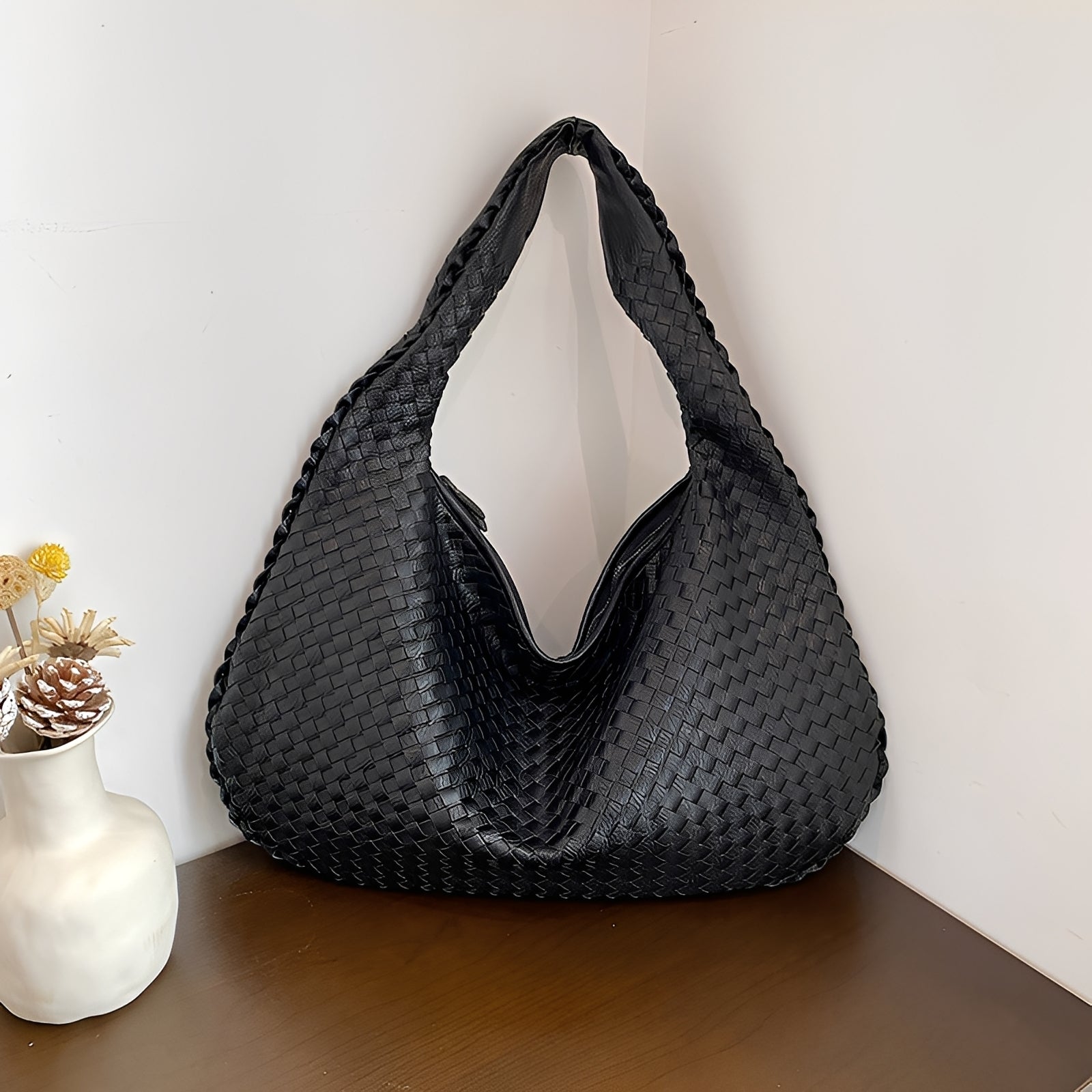 Women's woven faux leather shoulder bag styled as an everyday carry, full product view