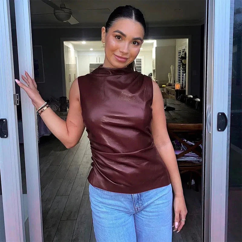 Women's sleeveless faux leather top with high neckline and figure-hugging silhouette