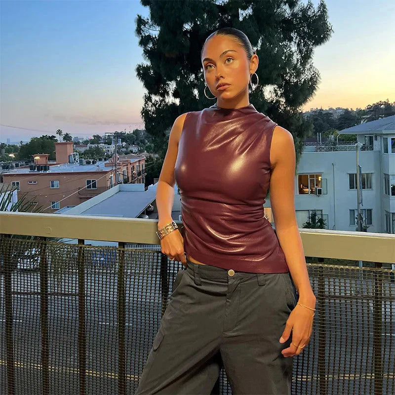 Faux leather sleeveless top for women featuring a structured high neck and hip-length cut