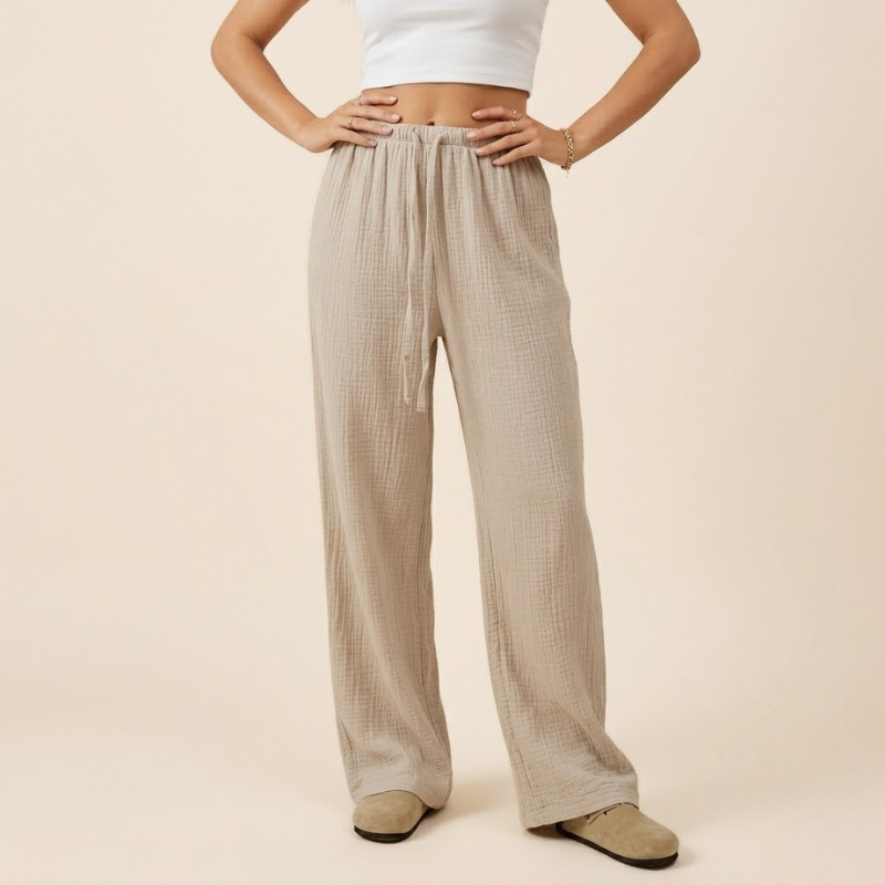 Wide-leg women's pants featuring an adjustable drawstring waist and clean minimalist seams