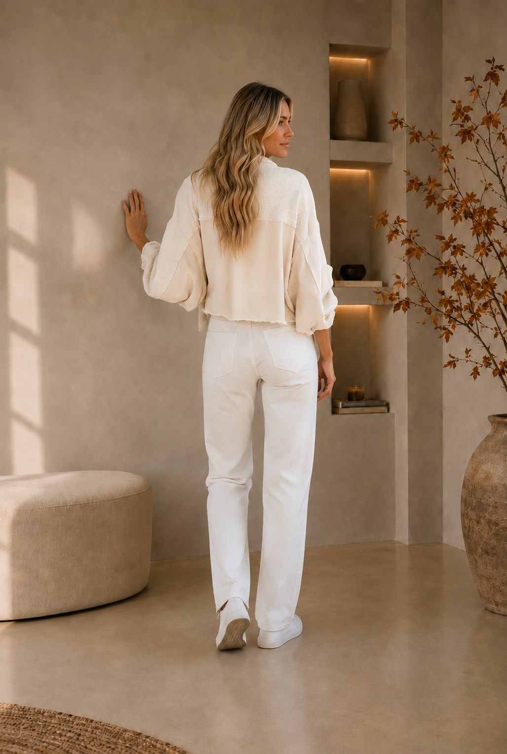Back view of women's white cropped jacket with frayed hem