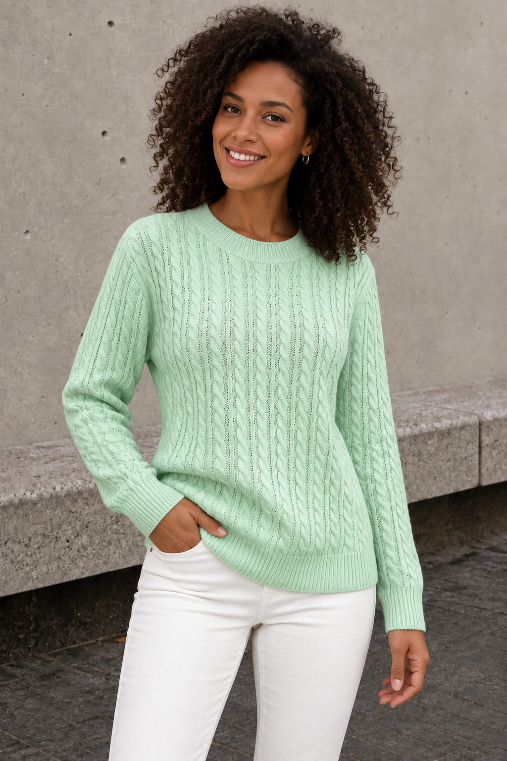 Women's mint green cable knit sweater with open-knit lines and ribbed cuffs, front view