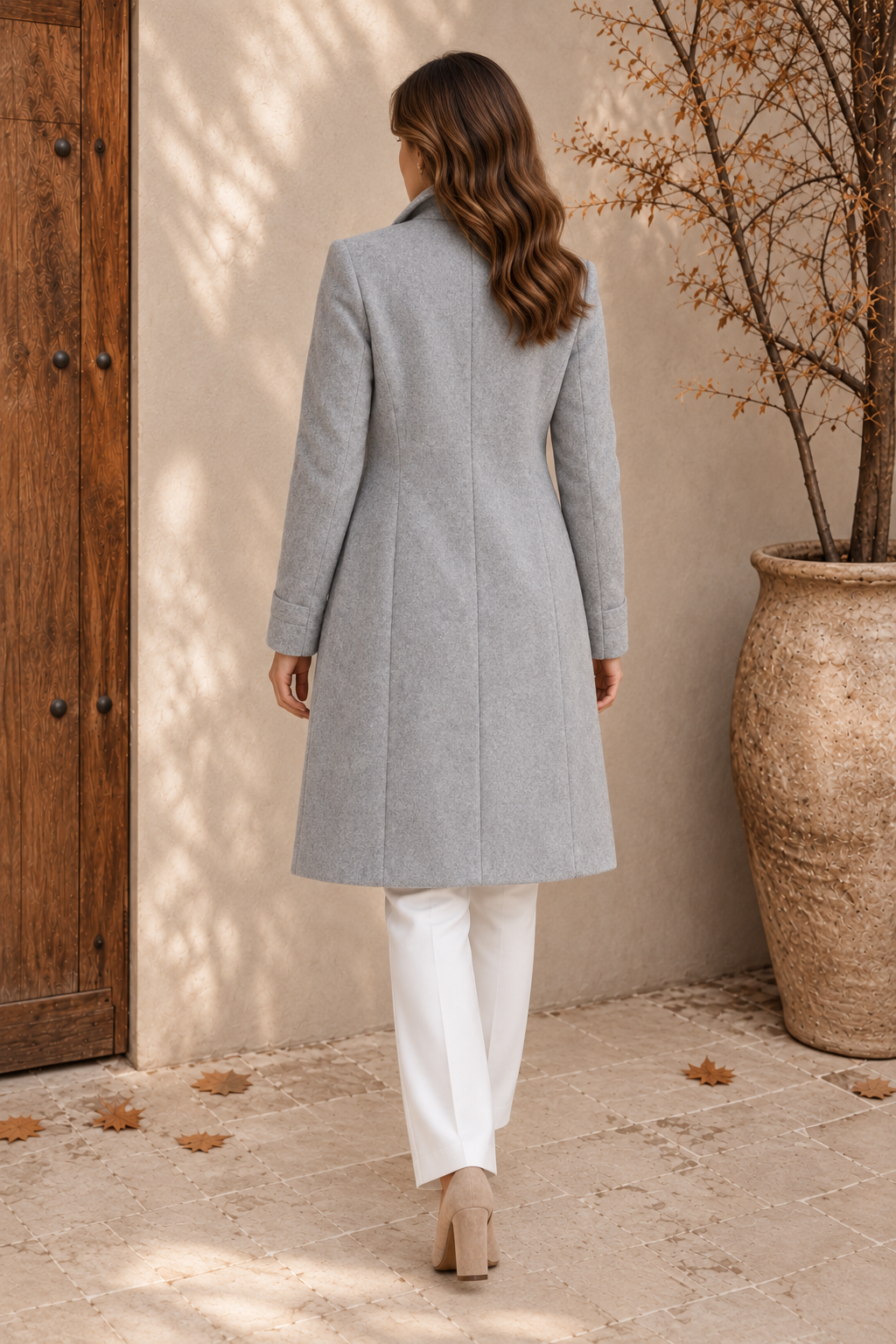 Women's light grey tailored coat with back shaping seams and turn-back cuffs, back view