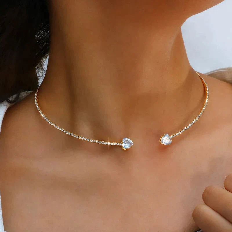 Close-up of women's metal choker necklace with zirconia stone elements and clasp