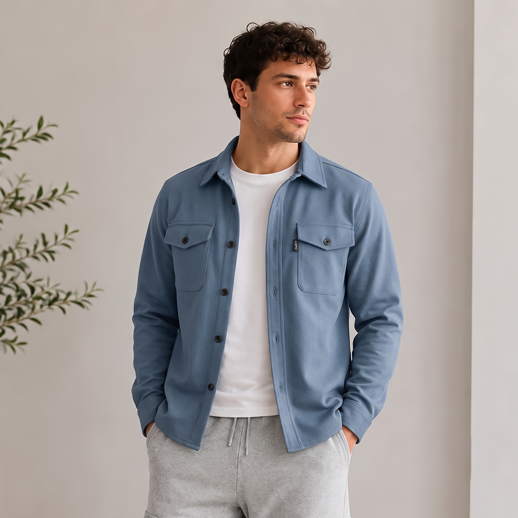 Men's woven overshirt with long sleeves, button cuffs, and structured chest pockets for autumn and spring