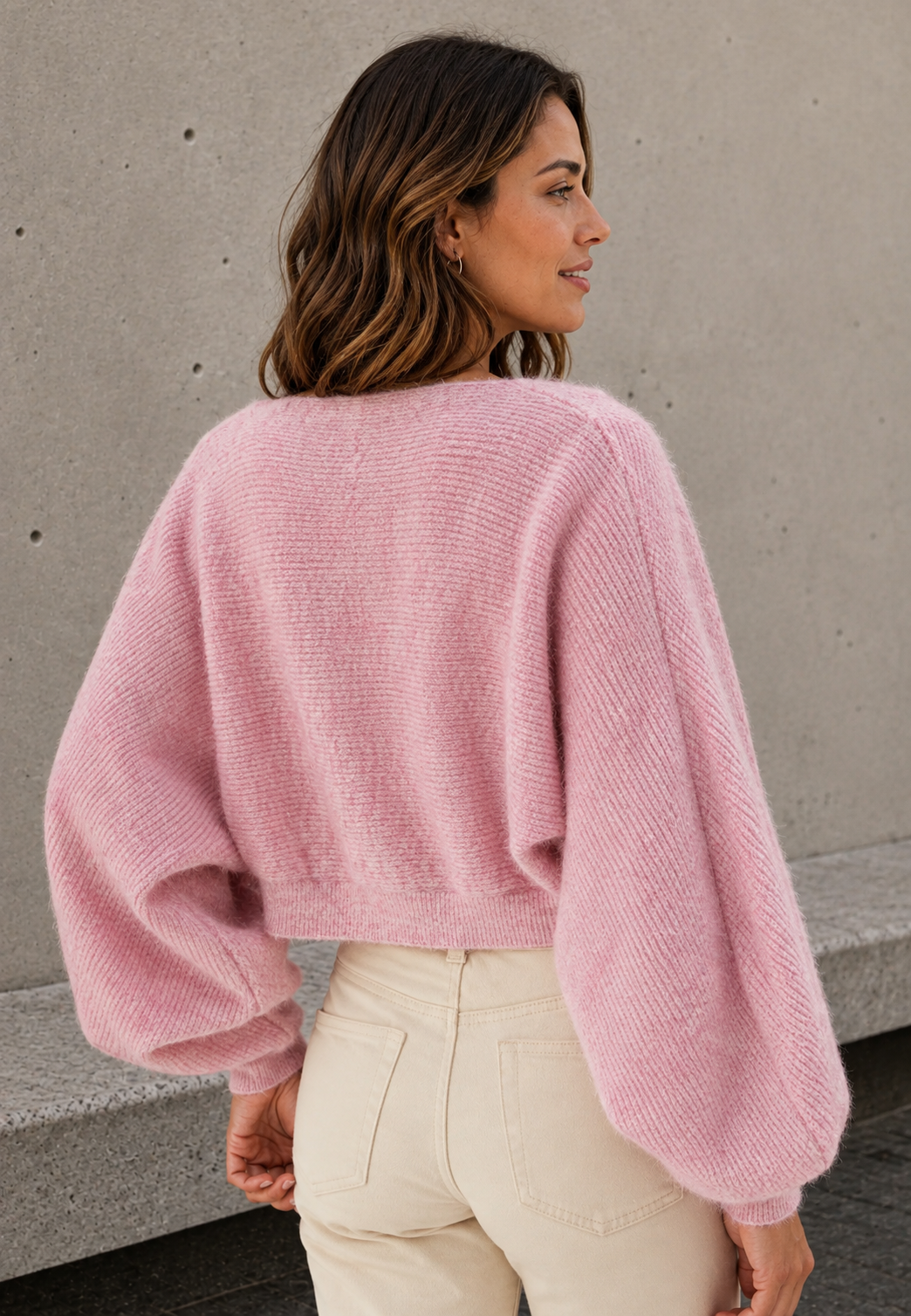 Pink knitted bolero back view with cropped fit