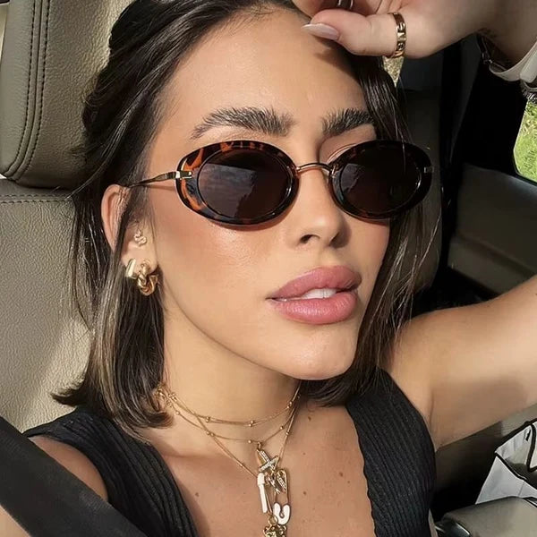 Woman wearing leopard oval sunglasses