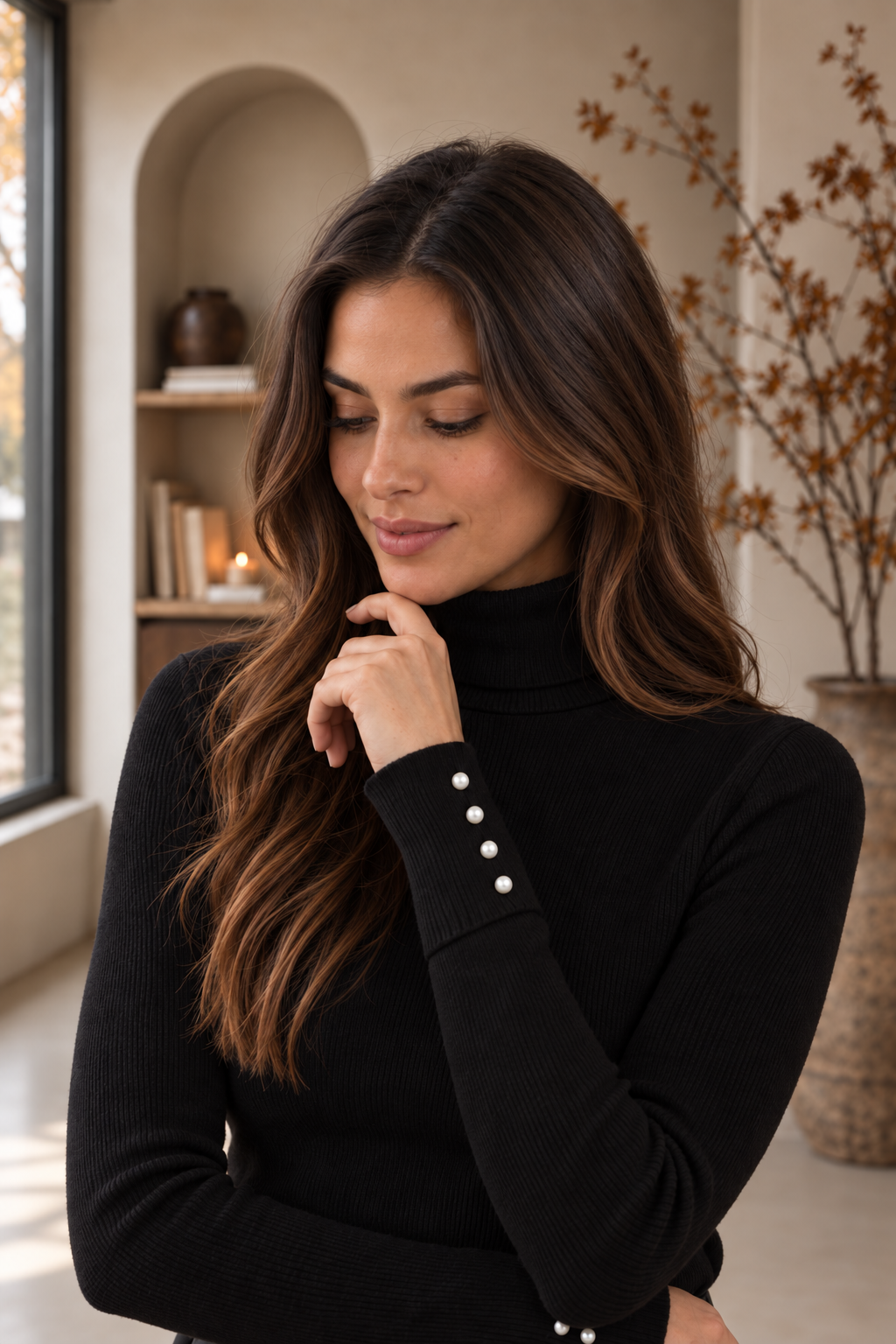 Women's black turtleneck sweater with button cuff details